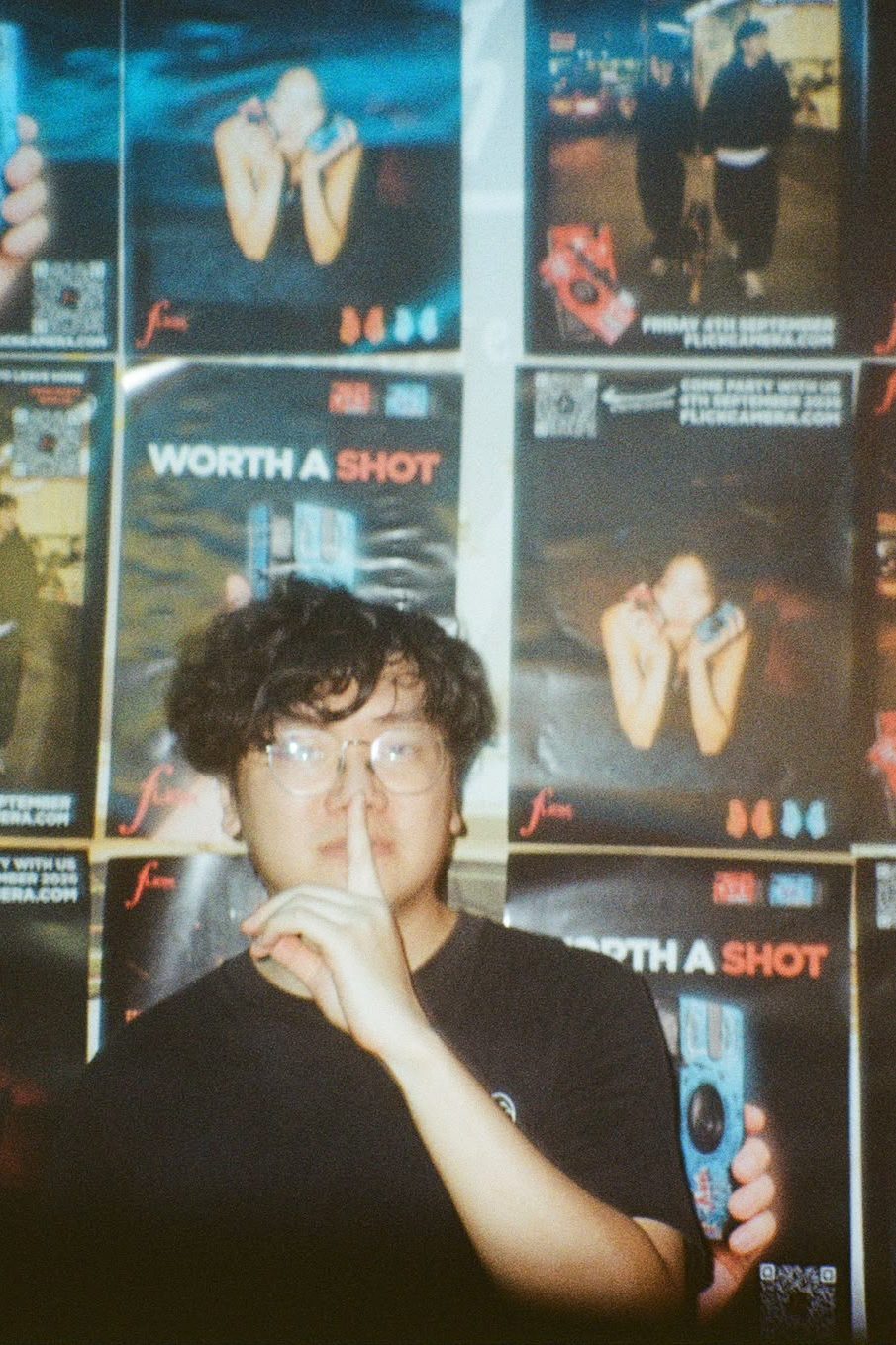 Guest holding a finger to his lips at the launch party